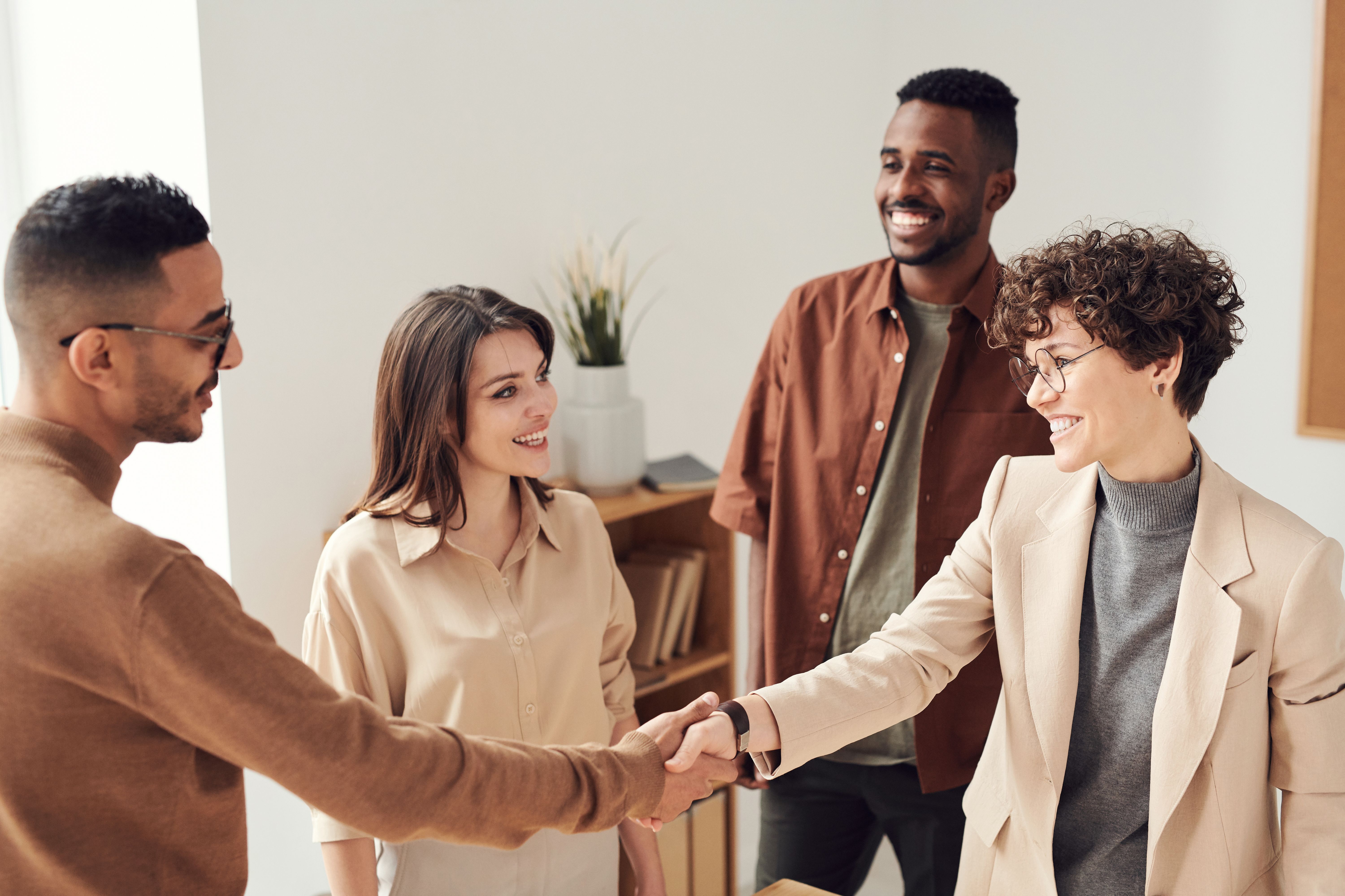 HumanRise team shaking hands with a client